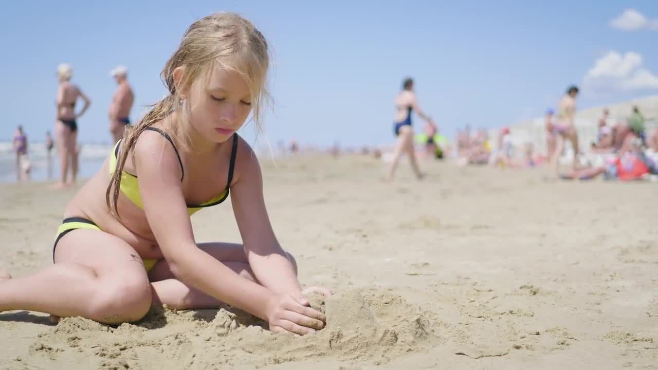 Child building a sandcastle on the beach