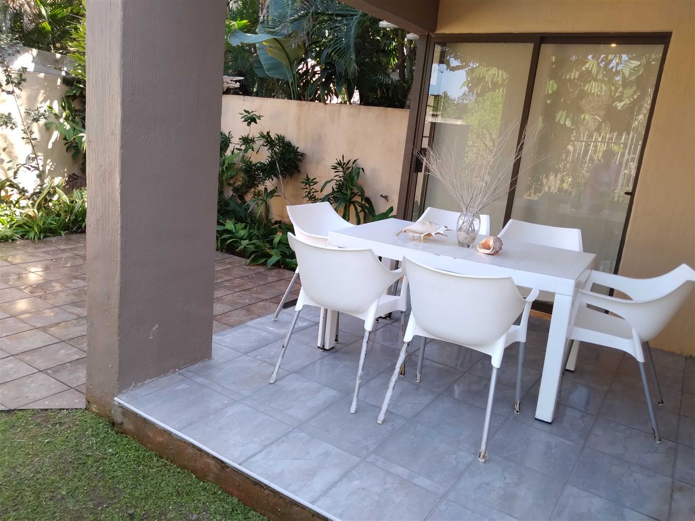 Shaded patio with table and chairs at Cabana Mio